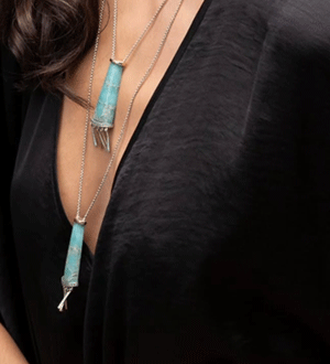 Conjunto de colares da marca portuguesa Pekan Jewellery com pendentes cilíndricos em tons de azul turquesa e detalhes prateados. 